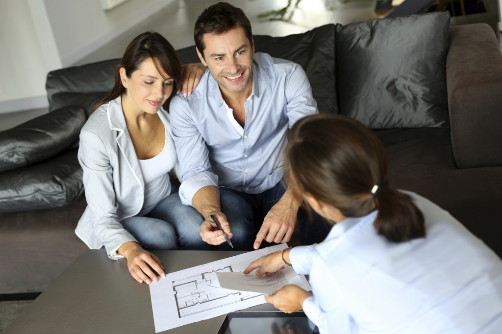Couple meeting adviser for property purchase